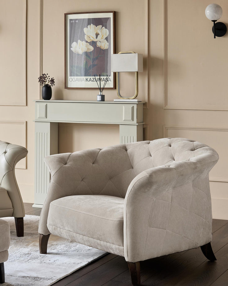 A stylish armchair, with buttoned detailing and dark wooden legs. Comfy seating with a luxury feel.