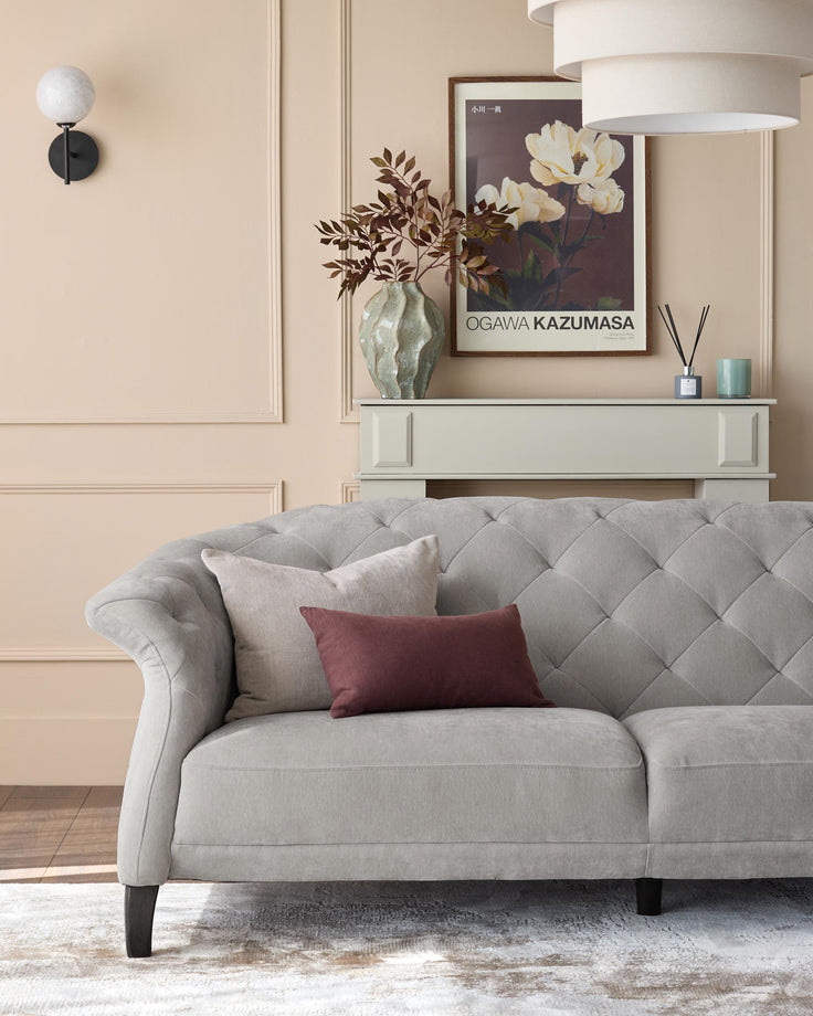 A plush, light-grey sofa sits beneath a stylish display unit in a warm, inviting living room setting.