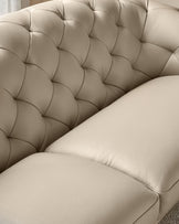 Close-up of a luxurious, button-tufted, beige leather sofa. Perfect for a sophisticated living space.