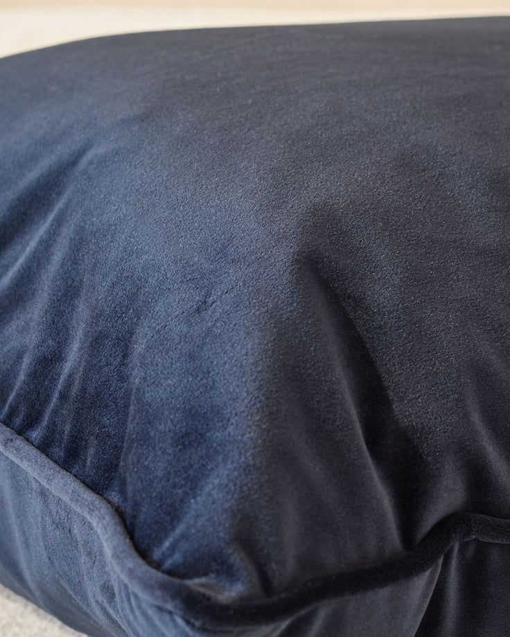 Close-up of navy blue Luca large cushion showing soft fabric texture and natural folds.