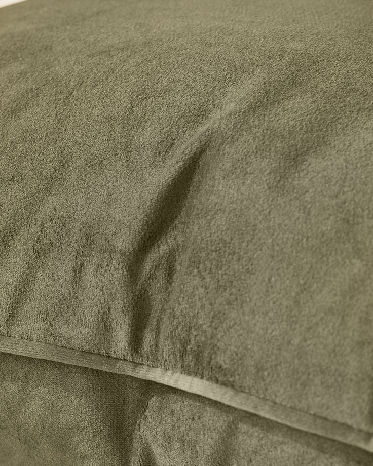 Close-up of Luca medium cushion in olive green, showing textured fabric and soft folds.