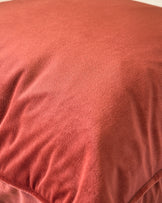 Luca rectangular cushion in toffee red, close-up showing soft fabric texture and subtle folds.