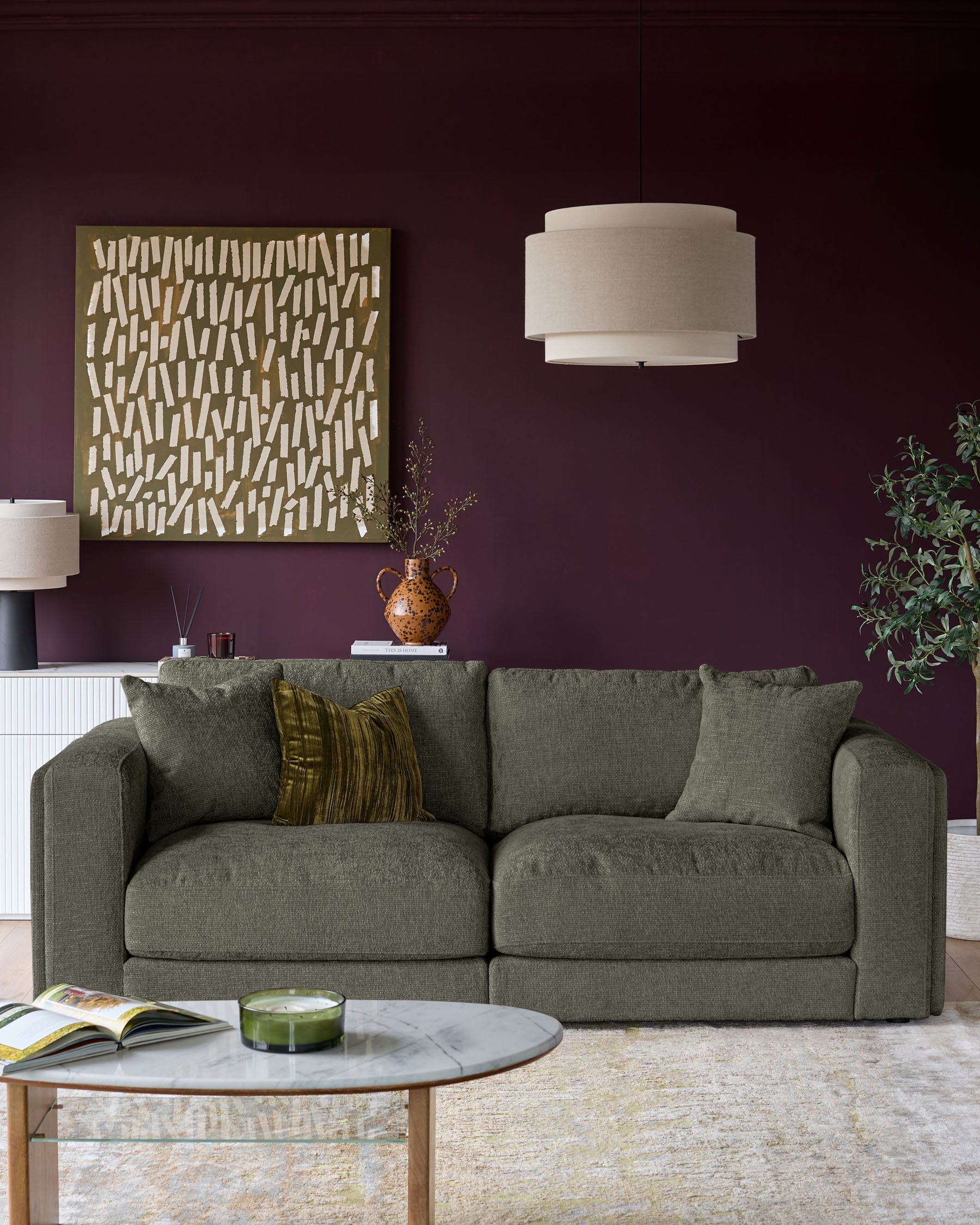 Lynetta 3-seater sofa in dark green weave fabric, displayed in a styled living room setting with cushions.
