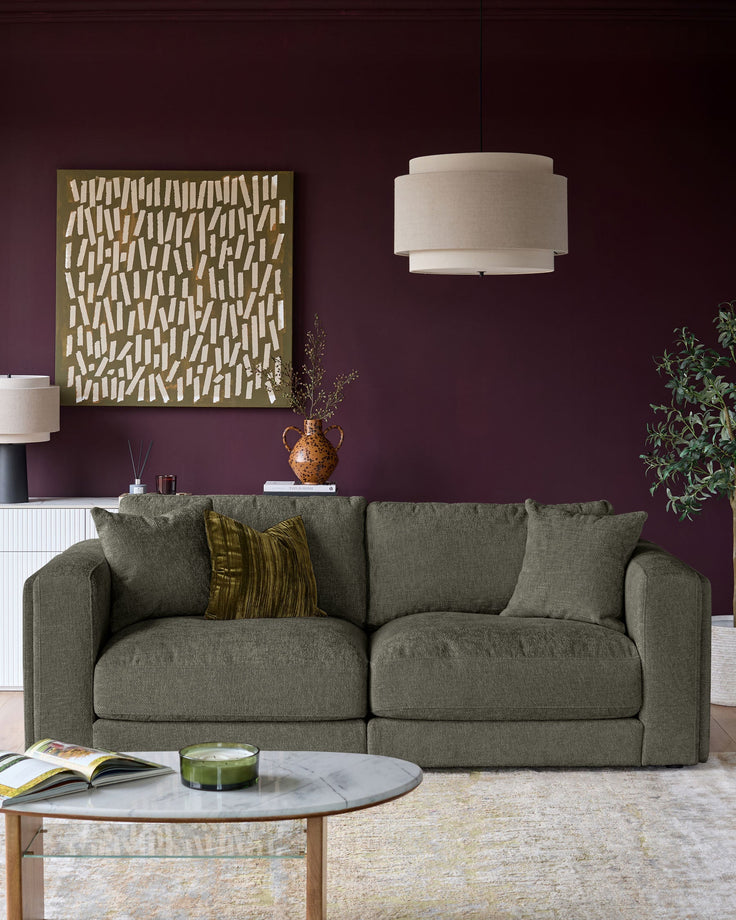Lynetta 3-seater sofa in dark green weave fabric, displayed in a styled living room setting with cushions.