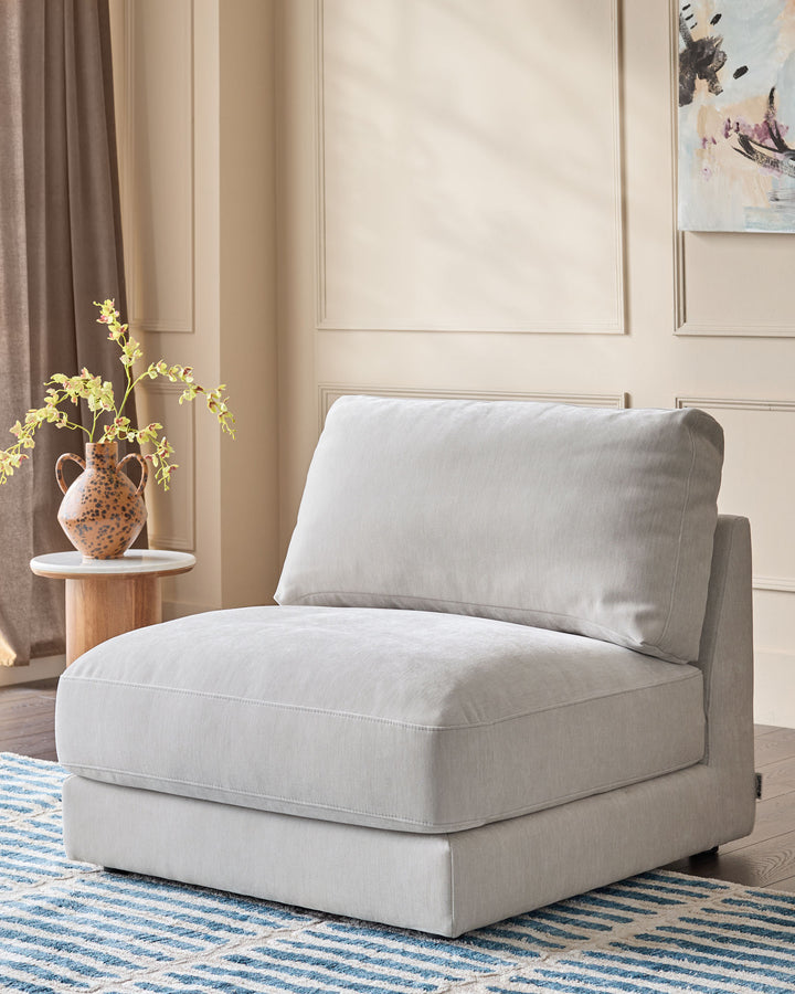 Lynetta single-module sofa in natural grey weave fabric, shown as a standalone armless chair with cushioned seat and back.