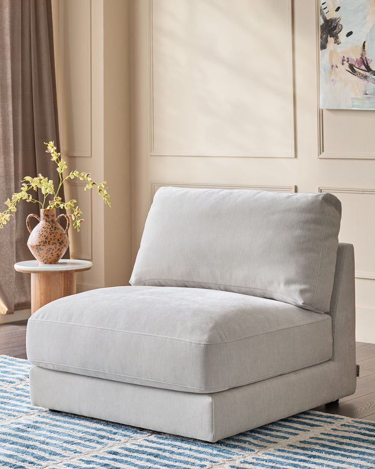 Lynetta single-module sofa in natural grey weave fabric, shown as a standalone armless chair with cushioned seat and back.