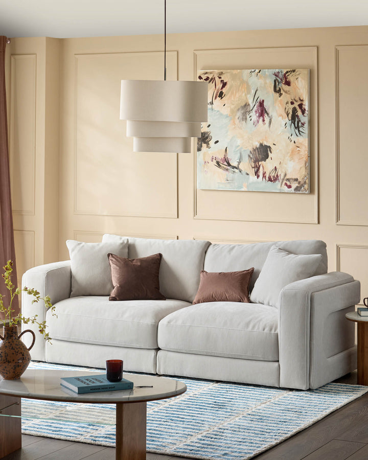 Lynetta 3-seater sofa in natural grey weave fabric, displayed in a bright living room setting with decorative pillows.