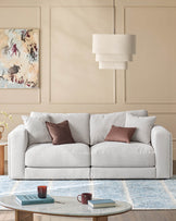 Lynetta 3-seater sofa in natural grey weave fabric, displayed in a modern living room setting with decorative pillows.