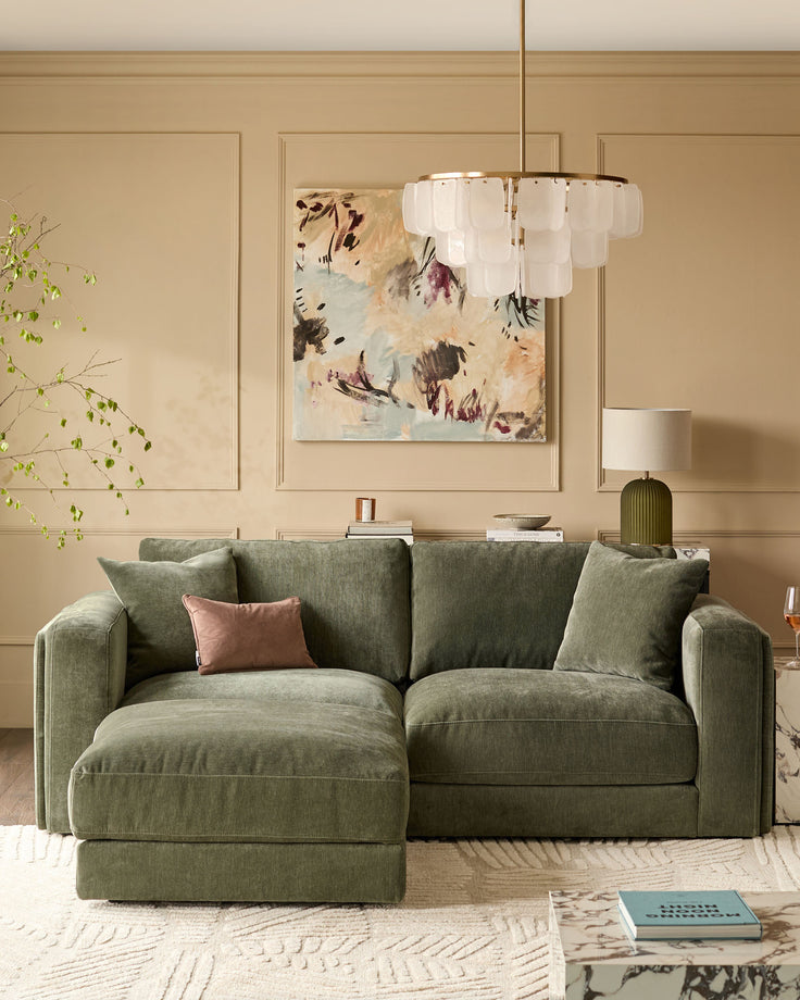 Lynetta 3-seater sofa with footstool in dark green weave fabric, displayed in a styled living room with coordinating decor.