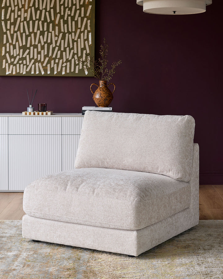 Lynetta single-module sofa in natural weave fabric, displayed in a modern living room setting with deep purple walls.