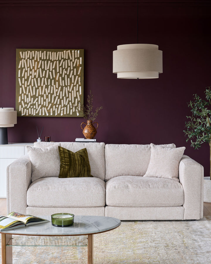 Lynetta 3-seater sofa in natural weave fabric, shown in a styled living room setting with decorative pillows.