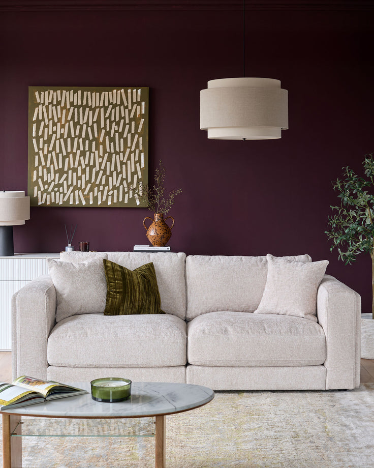 Lynetta 3-seater sofa in natural weave fabric, shown in a styled living room setting with decorative pillows.