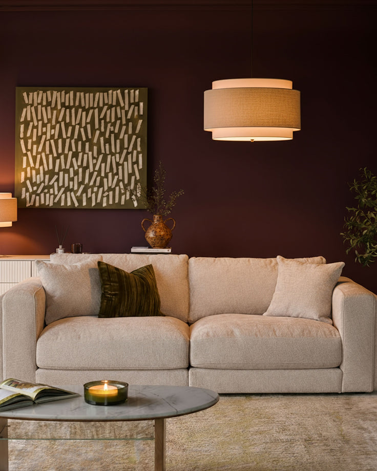 Lynetta 3-seater sofa in natural weave fabric, displayed in a warm living room setting with decorative pillows.