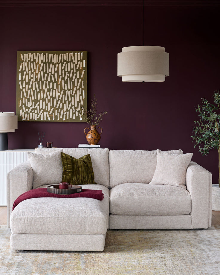 Lynetta 3-seater sofa with footstool in natural weave fabric, displayed in a styled living room setting.