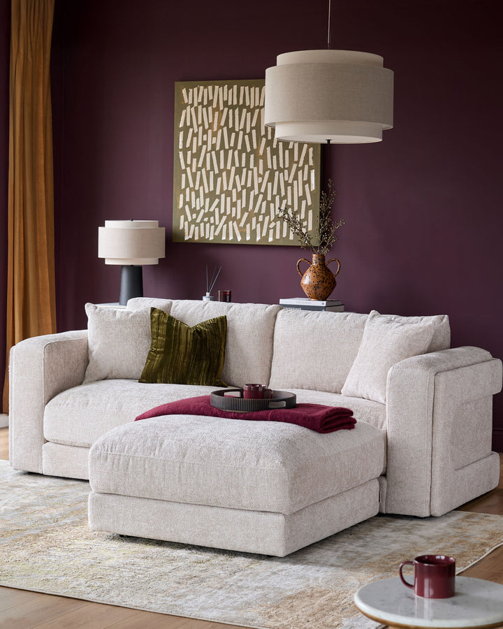 Lynetta 3-seater sofa with footstool in natural weave fabric, styled in a modern living room setting.