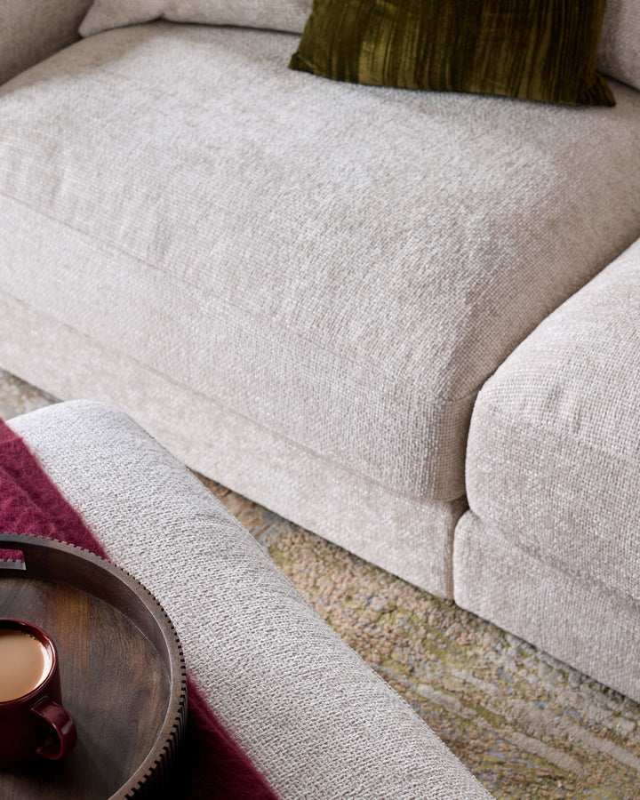Lynetta 3-seater sofa in natural weave fabric, angled view showing cushioned seat and armrest detail.