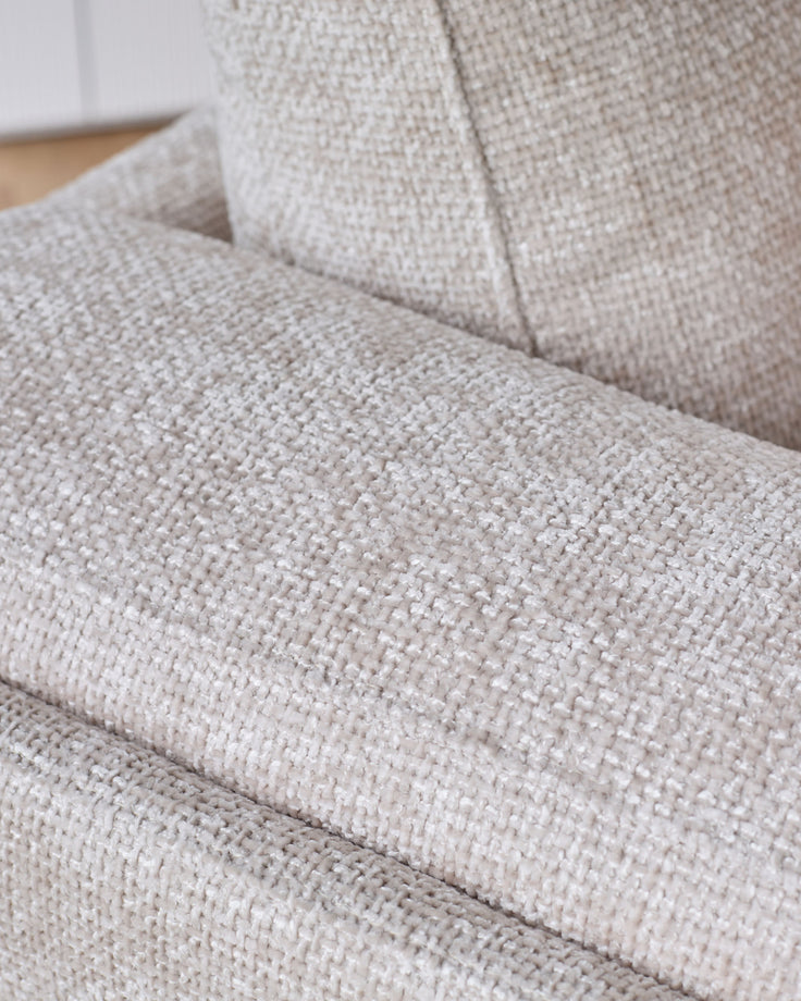 Close-up of natural weave fabric on Lynetta 3-seater sofa, showing textured beige upholstery and cushioned seat detail.
