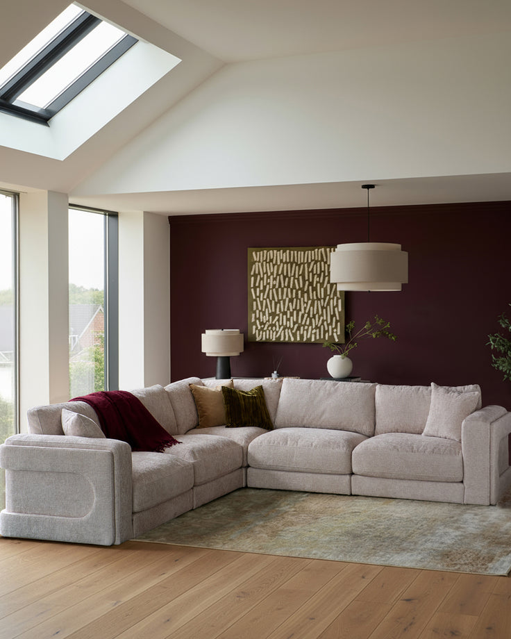 Lynetta single-module sofa in natural weave fabric, shown as part of a sectional arrangement in a modern living room setting.