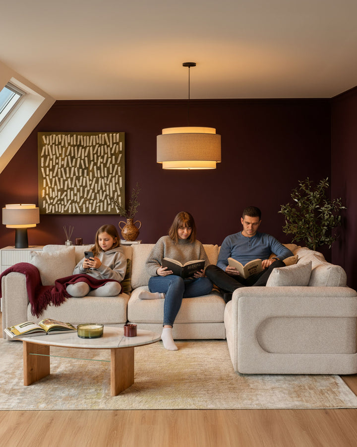 Lynetta small corner sofa in natural weave fabric, styled in a cozy living room with a family reading together.
