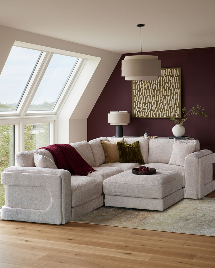 Lynetta small corner sofa with footstool in natural weave fabric, displayed in a modern living room setting.