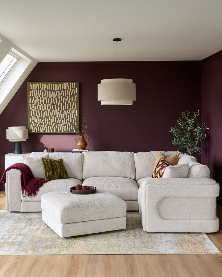 Lynetta small corner sofa with footstool in natural weave fabric, L-shaped configuration in a styled living room setting.