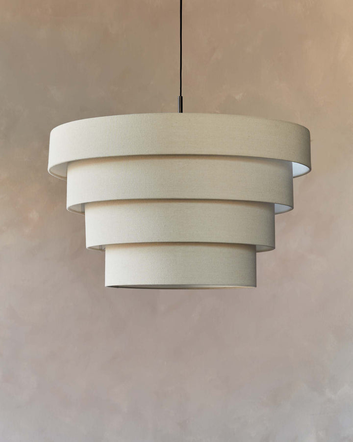 A beige, tiered pendant light hangs from the ceiling, creating a soft and warm ambience within the room.