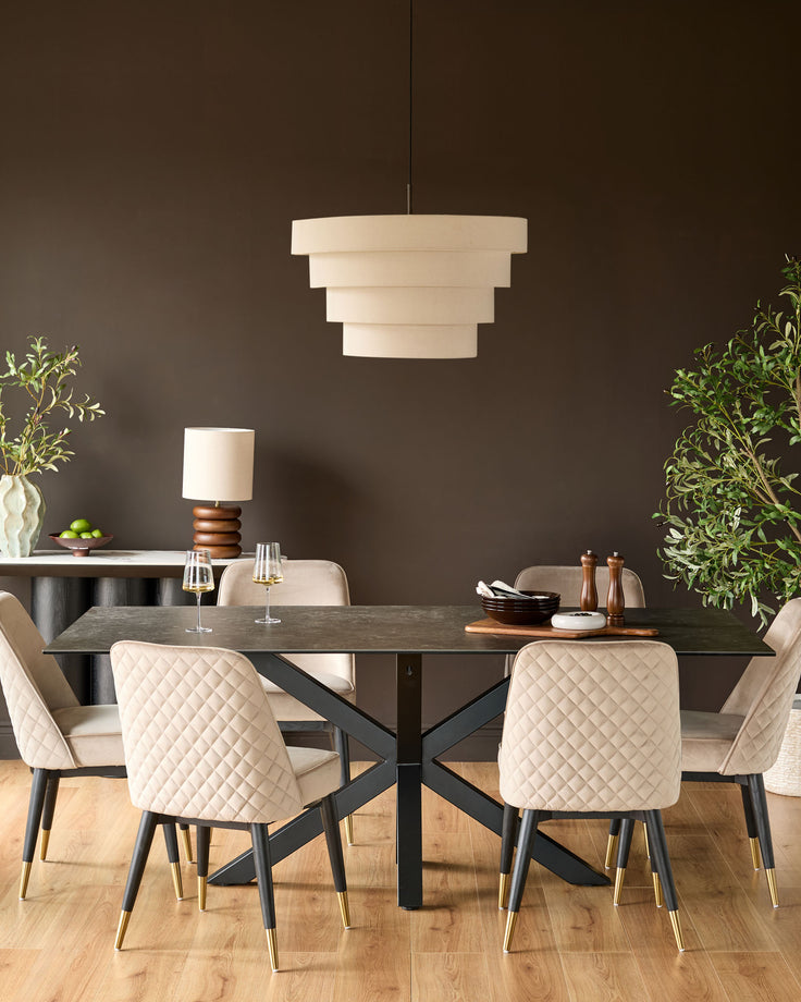 Mae velvet dining chair in champagne, shown in a styled dining room setting with black table and pendant light.