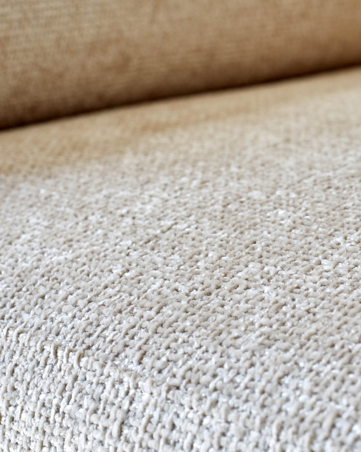 Close-up of a beige textured sofa, showing the fabric detail. A neutral colour with subtle texture.