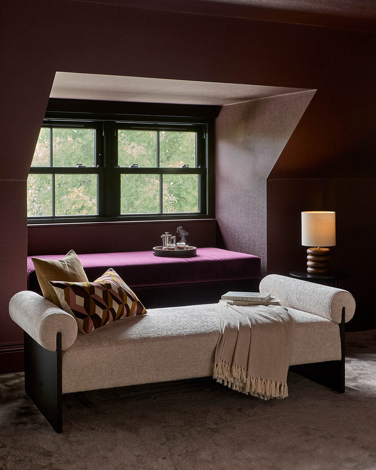 Hepworth table light with dark wood base and natural linen shade, displayed in a styled living room setting.