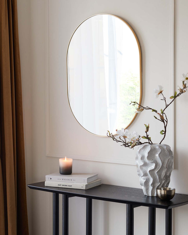 Elegant narrow console table with a black metal frame and a textured dark grey tabletop. The design is minimalist and contemporary, suitable for a variety of home decor styles. Perfect for displaying decorative objects and essential items in an entryway or living room.