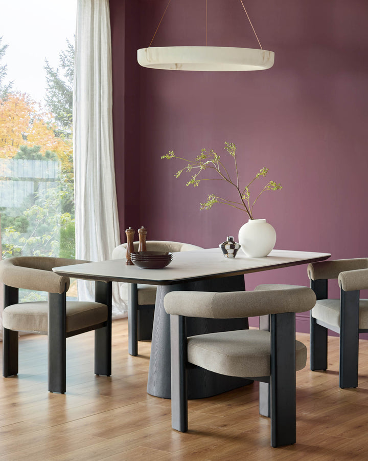 Manhattan 8-seater dining table in white ceramic with black cylindrical legs, styled in a modern dining room.