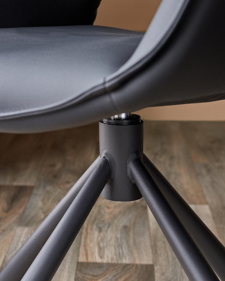 Close-up of a grey swivel chair base showing the stylish metal legs and connection to the seat.