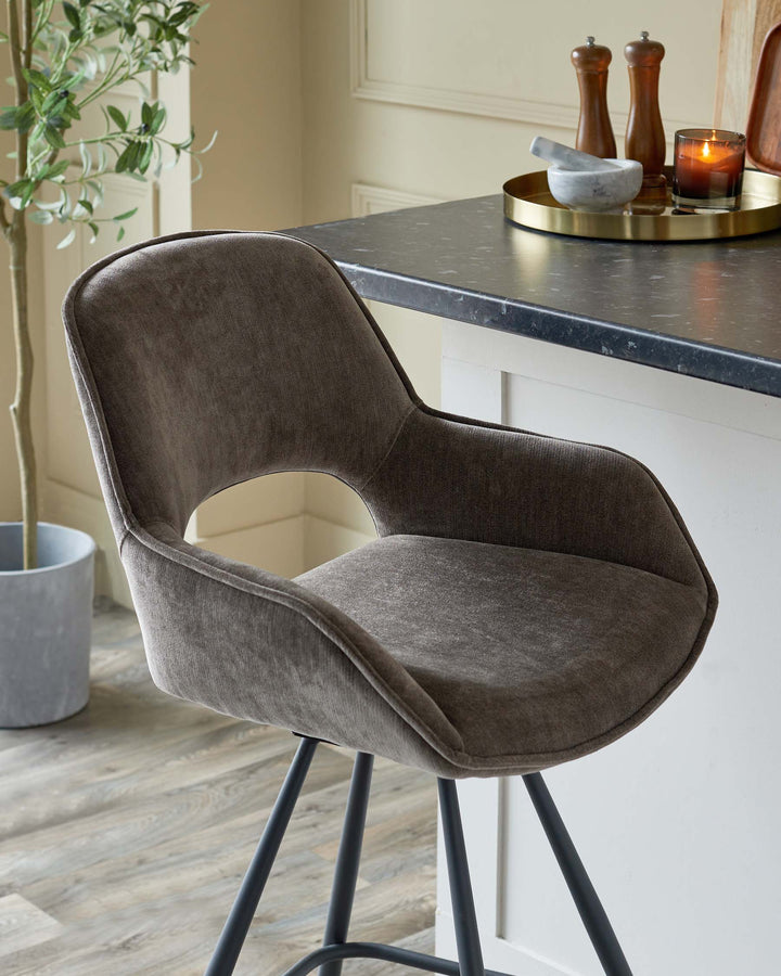 Stylish bar stool with grey upholstery and black metal legs. Perfect for adding a touch of modern elegance to any kitchen.
