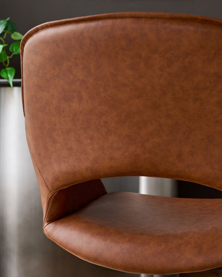 Tan leather swivel dining armchair with curved backrest and metal base, shown from side angle.