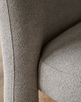 Mason 3-seater dining bench in light grey boucle, close-up of curved armrest and seam detail.