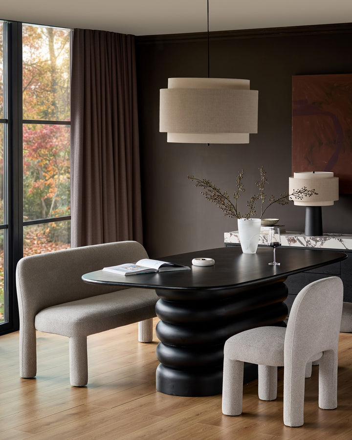 Mason 3-seater dining bench in light grey boucle, shown in a modern dining setting with black table and chairs.