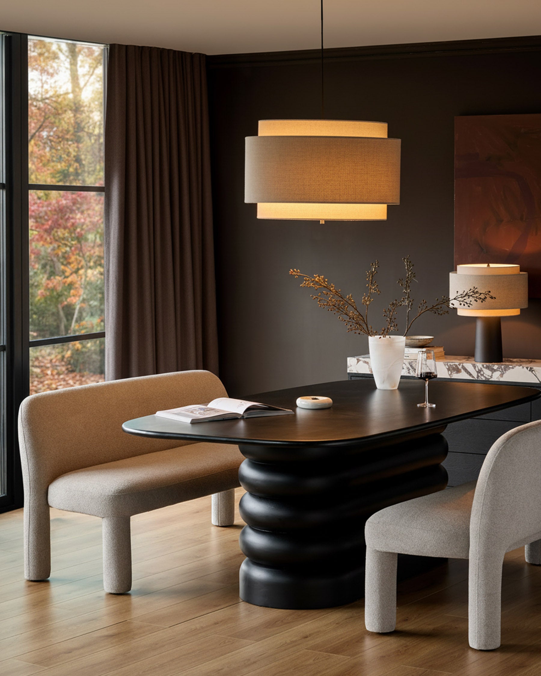 Mason 3-seater dining bench in light grey boucle, shown in modern dining room setting with black table.