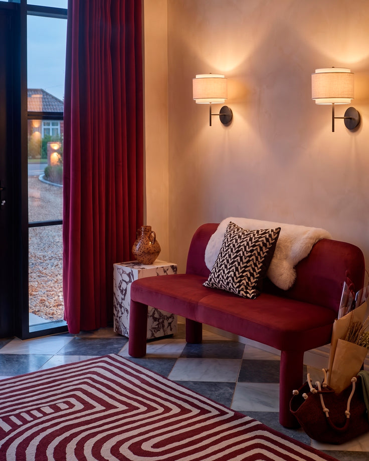 Plum velvet 3-seater bench with curved arms, styled in a modern entryway with decorative pillows and throw blanket.