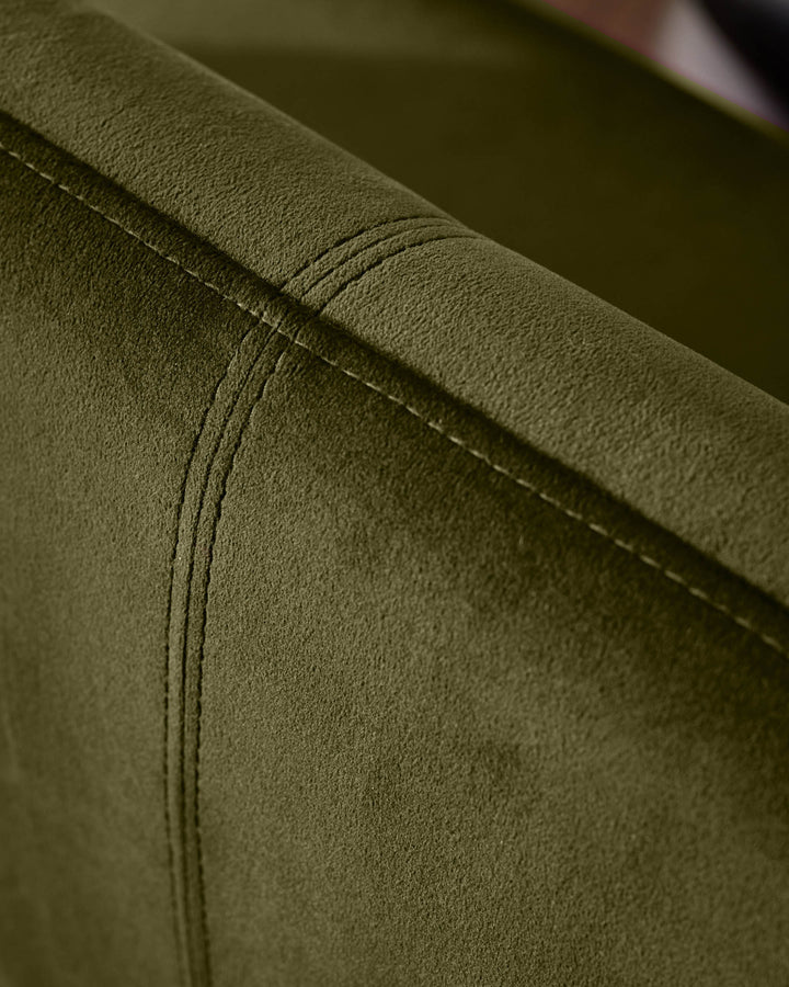 Close-up of olive green velvet fabric on Mason dining bench, showing stitched seam detail.