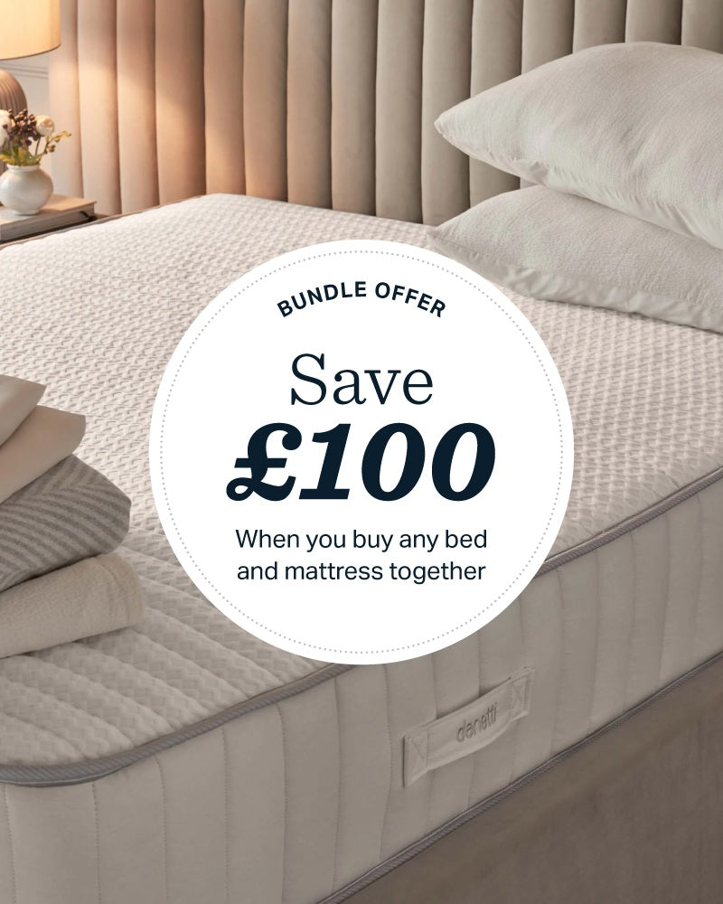 Taylor super king ottoman bed in mid-grey fabric with white pillows and bedding, styled in a bedroom setting.