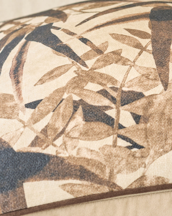 Madeira cushion in natural tones featuring botanical leaf pattern in cream, tan, and charcoal.