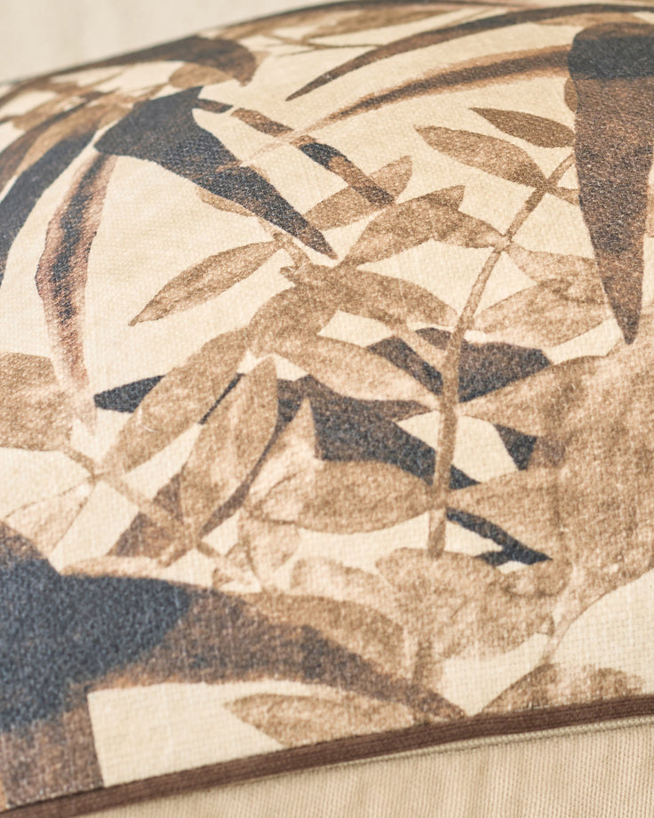Madeira cushion in natural tones featuring botanical leaf pattern in cream, tan, and charcoal.
