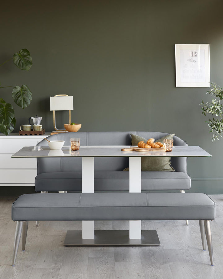 A stylish dining set with a grey table, bench, and banquette seating, creating a modern and inviting dining space.