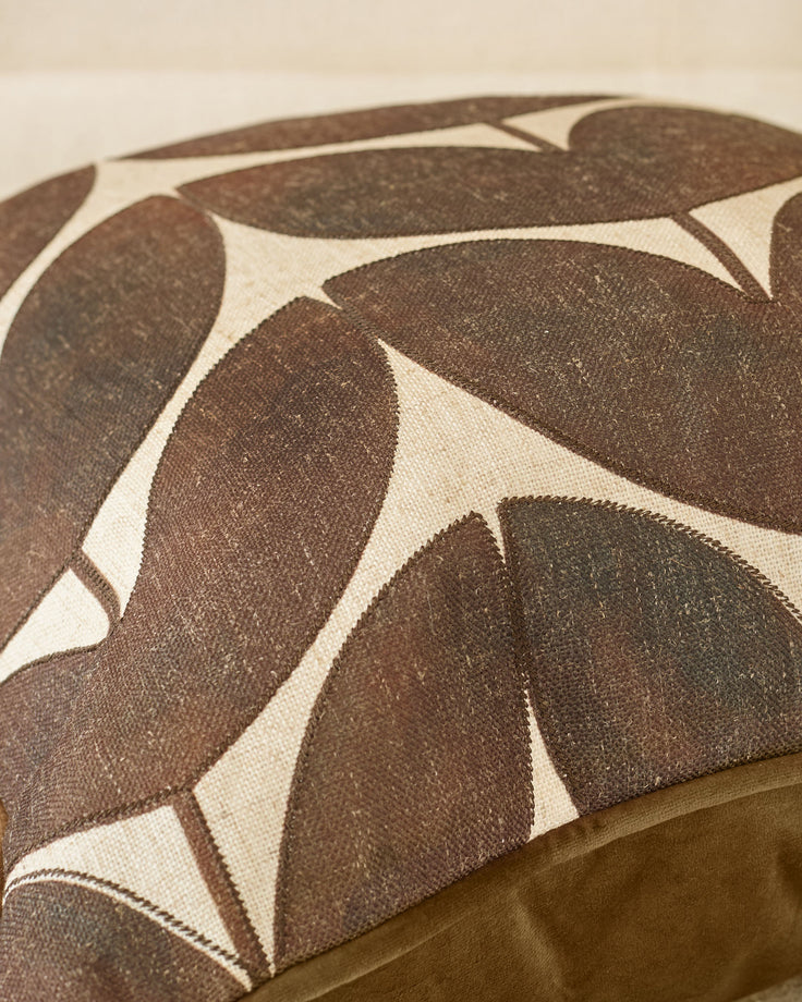 Micah cushion in chocolate brown and cream leaf pattern, close-up detail view showing fabric texture.
