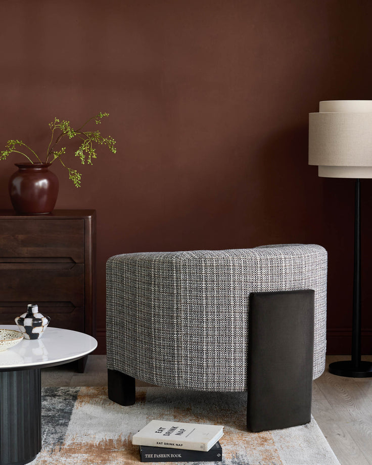 Miles occasional chair in light Grey fabric with dark chocolate velvet side panel, shown in modern interior setting.