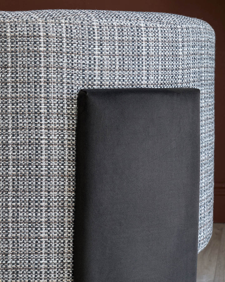 Miles Occasional Chair in light Grey textured fabric with dark chocolate velvet leg detail, angled side view.
