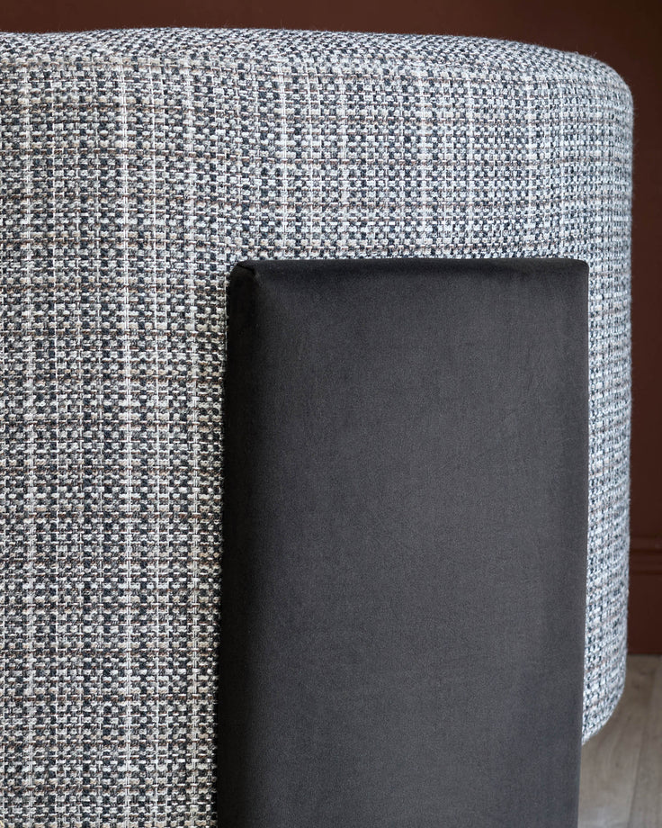 Miles Occasional Chair in light Grey textured fabric with dark chocolate velvet leg detail, angled side view.