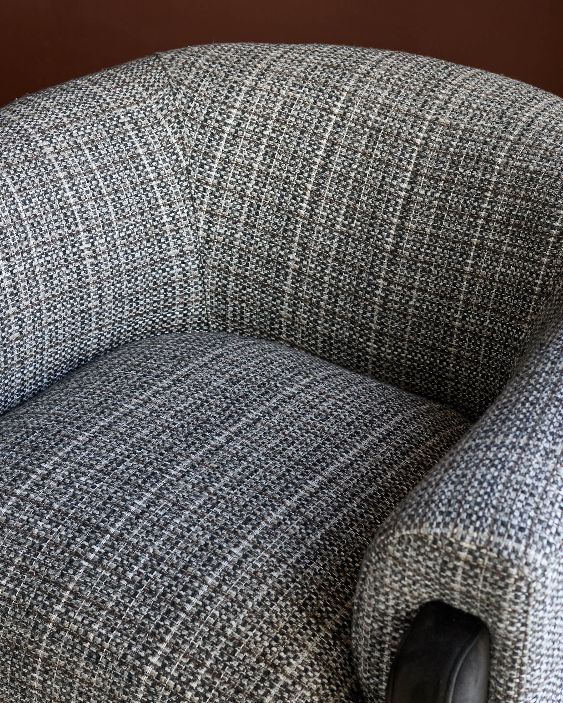 Miles Occasional Chair in dark chocolate fabric, showing curved armrest and textured upholstery detail from above.