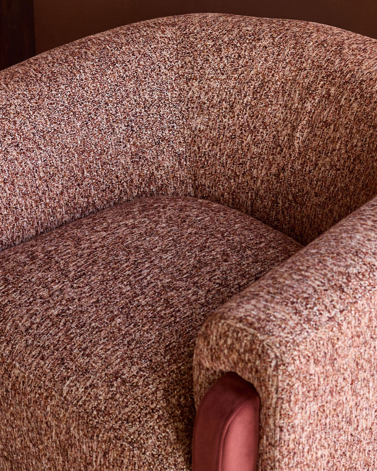 Miles occasional chair in toffee fabric, showing curved armrest and seat detail from above.