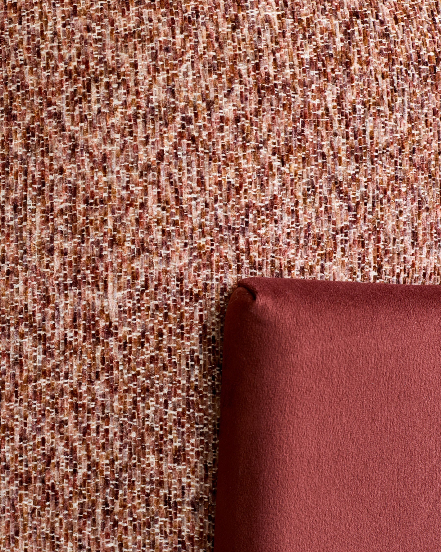 Toffee red textured fabric with burgundy velvet backing, shown rolled to display weave pattern and color depth.